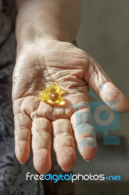 Elderly Hand With Supplement Stock Photo