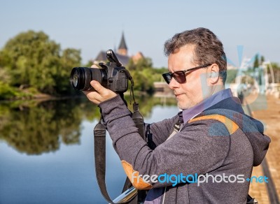 Elderly Man Photographs The Landscape Stock Photo