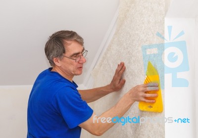 Elderly Worker Smoothing Wallpaper Stock Photo