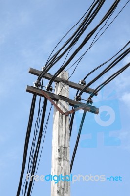 Electric Cable On Pole In Blue Sky Stock Photo