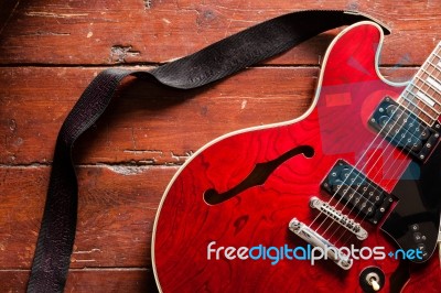 Electric Guitar On Wood Background Illuminated By Natural Daylight Stock Photo