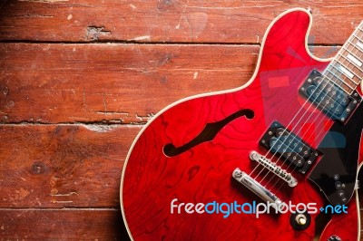 Electric Guitar On Wood Background Illuminated By Natural Daylight Stock Photo