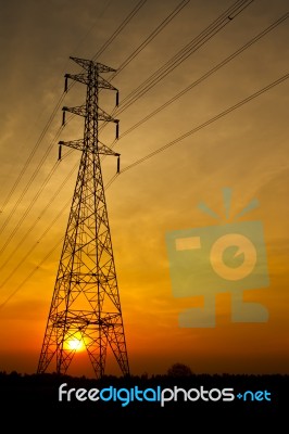 Electric Pylon At Sunset Stock Photo