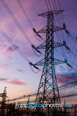 Electricity Pillars Against Colorful Sunrise Stock Photo