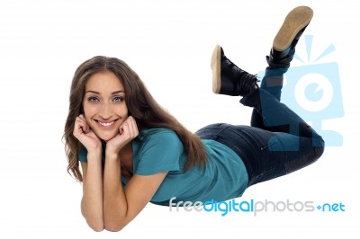 Elegant Female With Cheeky Expression Relaxing On The Floor Stock Photo