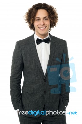 Elegant Man In Tuxedo Posing Over White Stock Photo