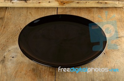 Empth Black Plate On The Wooden Background Stock Photo