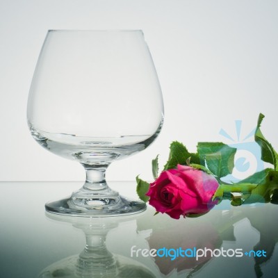 Empty Brandy Glass And Rose Stock Photo