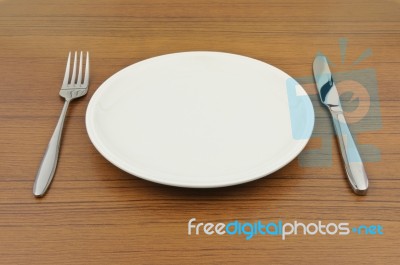 Empty Dish On Wood Table Stock Photo