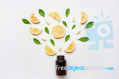 Empty Medicine Bottle With Fresh Lemon, Leaves And Vitamin C Stock Photo