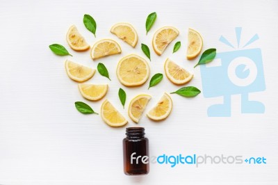 Empty Medicine Bottle With Fresh Lemon Slices And Leaf Stock Photo