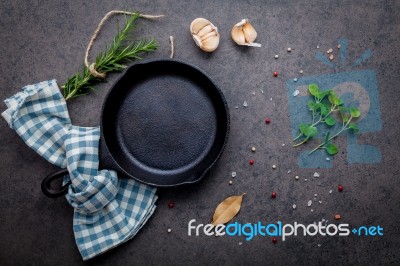 Empty Old Cast Iron Skille On Dark Stone Background. Ingredients… Stock Photo