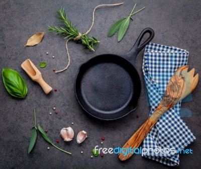 Empty Old Cast Iron Skille On Dark Stone Background. Ingredients… Stock Photo