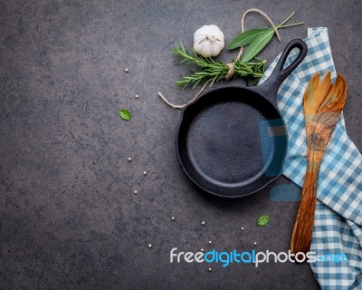 Empty Old Cast Iron Skille On Dark Stone Background. Ingredients… Stock Photo