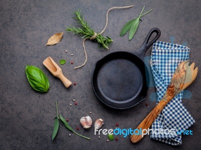 Empty Old Cast Iron Skille On Dark Stone Background. Ingredients… Stock Photo