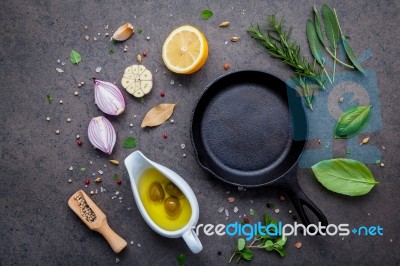 Empty Old Cast Iron Skille On Dark Stone Background. Ingredients… Stock Photo