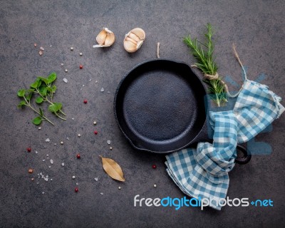 Empty Old Cast Iron Skille On Dark Stone Background. Ingredients… Stock Photo