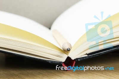 Empty Pages Of Opened Notebook With Pencil Stock Photo