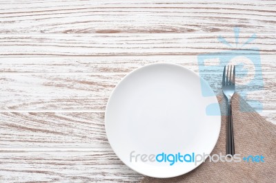 Empty Plate Napkin Fork Silverware White Wooden Table Background… Stock Photo