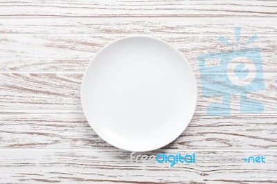 Empty Plate On White Wooden Table Background  Flat Lay Stock Photo