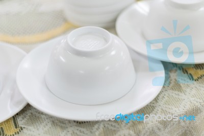 Empty White Plate And Small Chalice On Table Stock Photo