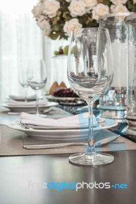 Empty Wine Glass On Wooden Dinning Table With Table Set Stock Photo