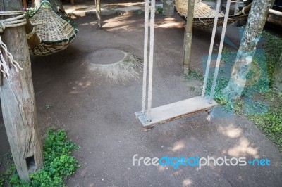 Empty Wooden Swing In The Garden Stock Photo