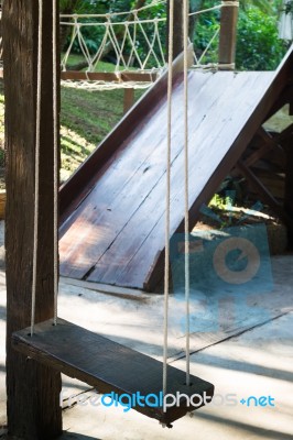 Empty Wooden Swing In The Garden Stock Photo