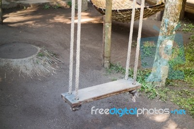 Empty Wooden Swing In The Garden Stock Photo