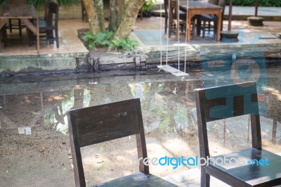 Empty Wooden Table And Chair In Local Restaurant Stock Photo