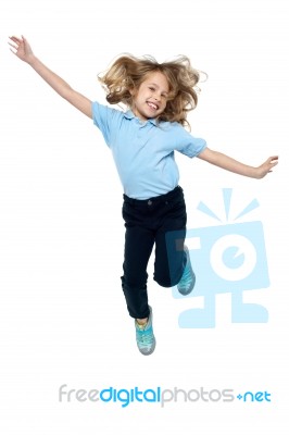 Energetic Young Child Jumping High Stock Photo