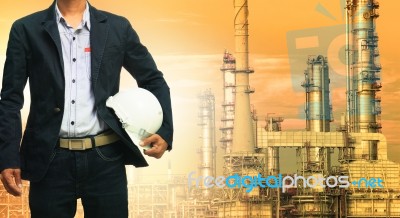 Engineering Man And Safety Helmet Standing Against Oil Refinery Stock Photo