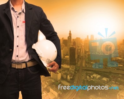 Engineering Man And Sun Light Behind Urban Construction Backgrou… Stock Photo