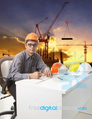 Engineering Man With Safety Helmet Working Table Against Buildin… Stock Photo