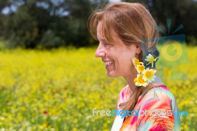 European Woman Wearing Braid With Yellow Flowers Near Coleseed F… Stock Photo