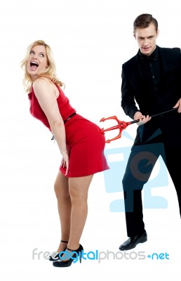 Evil Guy Poking Sensual Woman Stock Photo