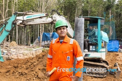 Excavator And Workers Stock Photo