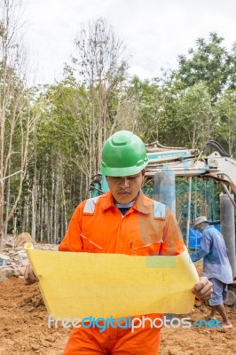 Excavator And Workers Stock Photo