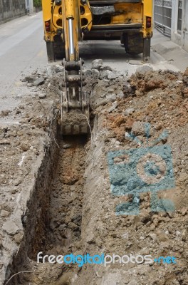 Excavator Digging Soil For Pipe Intake Stock Photo