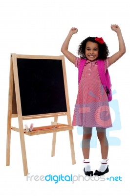 Excited Beautiful Little Girl In School Uniform Stock Photo