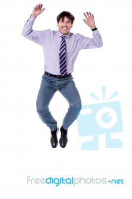 Excited Businessman Jumping High Stock Photo