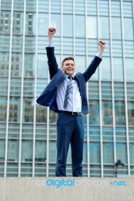 Excited Businessman Raising His Arms Stock Photo