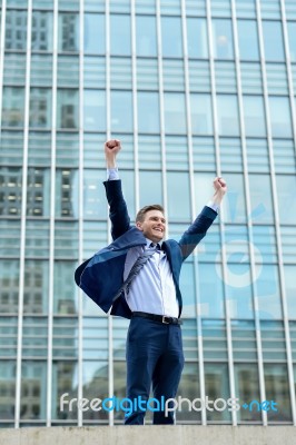 Excited Businessman Raising His Arms Stock Photo