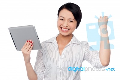 Excited Businesswoman Holding Touch Pad Stock Photo