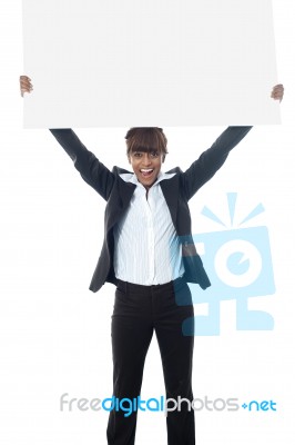 Excited Businesswoman Poisng With Billboard Stock Photo