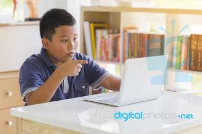 Excited Child Reading Online Laptop Computer Content At Library Stock Photo