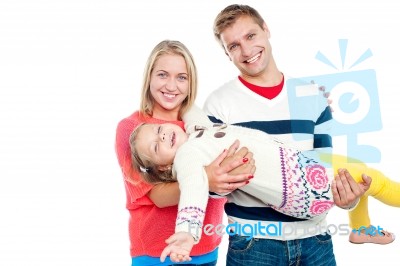 Excited Daughter Having Fun In Safe Hands Of Her Parents Stock Photo