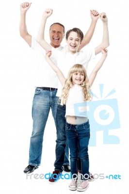 Excited Family With Arms Up Stock Photo