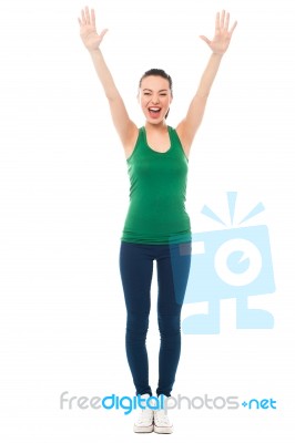 Excited Fitness Girl Raising Her Hands Stock Photo