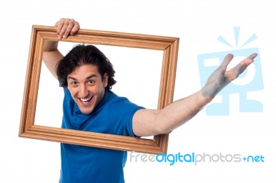 Excited Man Holding Picture Frame Stock Photo